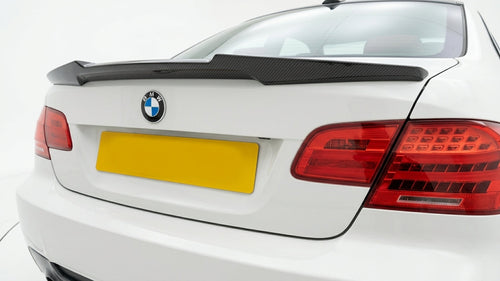Carbon Corp. BMW E92 M Performance style dry carbon fiber rear lip spoiler on a white coupe trunk