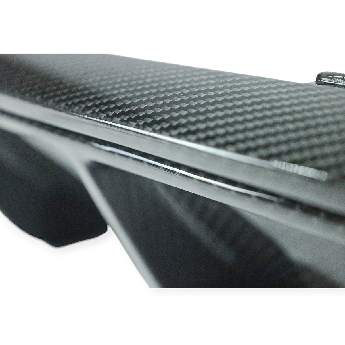 Carbon Corp. BMW M2 F87 rear diffuser featuring a high-gloss twill weave carbon fibre finish and sharp aerodynamic fins