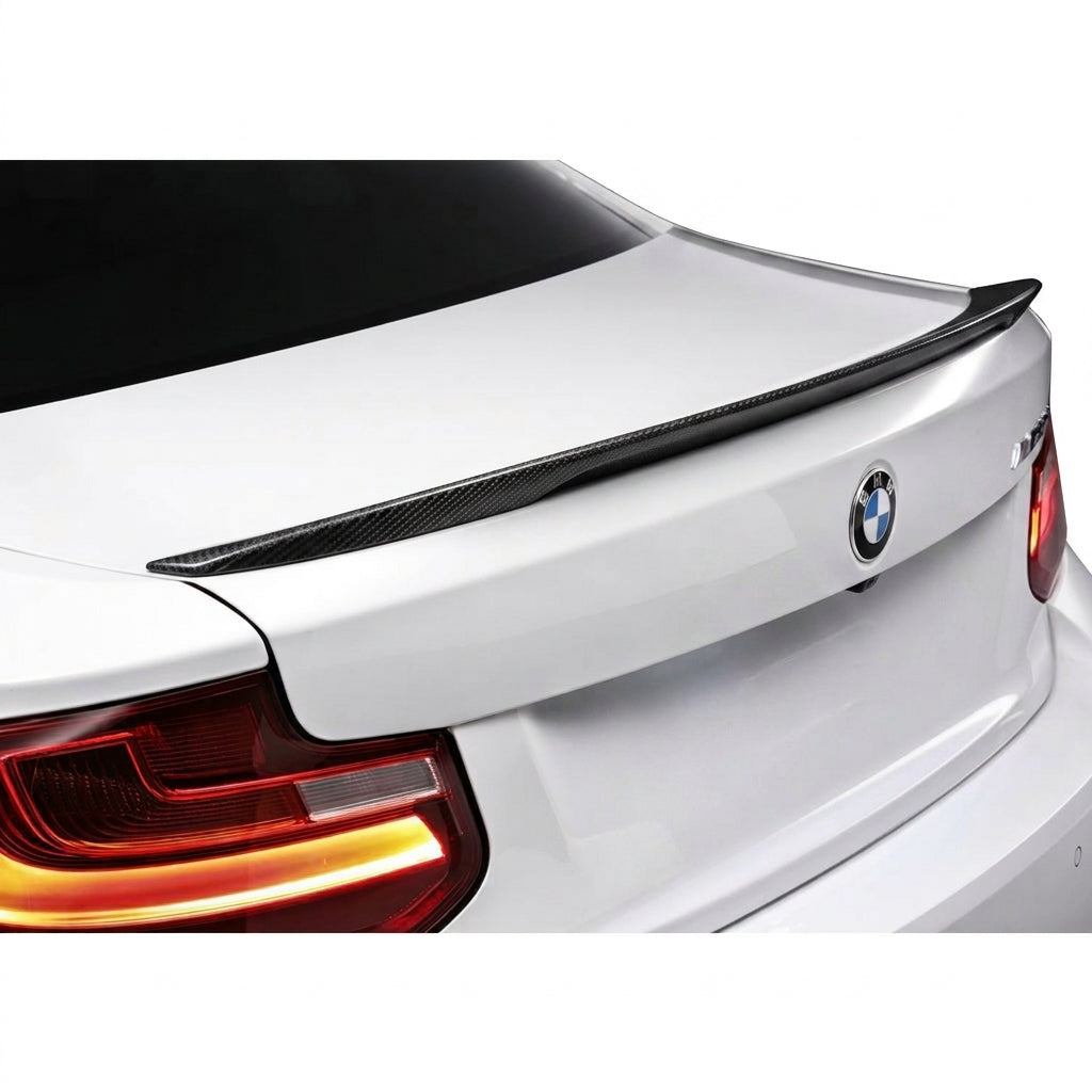 Carbon Corp. M Performance style carbon fibre lip spoiler installed on the trunk of a white BMW M2 F87