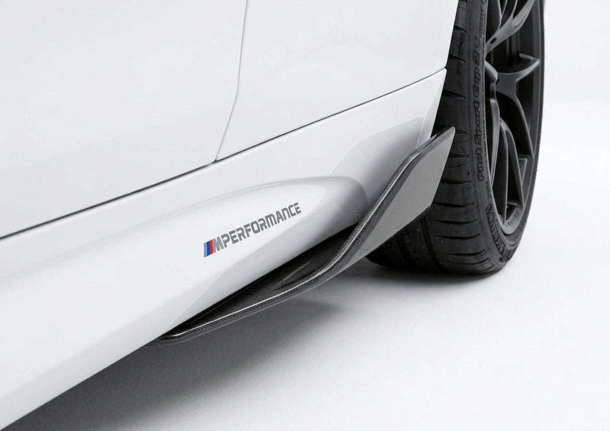 Carbon Corp. M Performance style carbon fiber side skirt winglet installed on a white BMW M2 F87 rear wheel arch