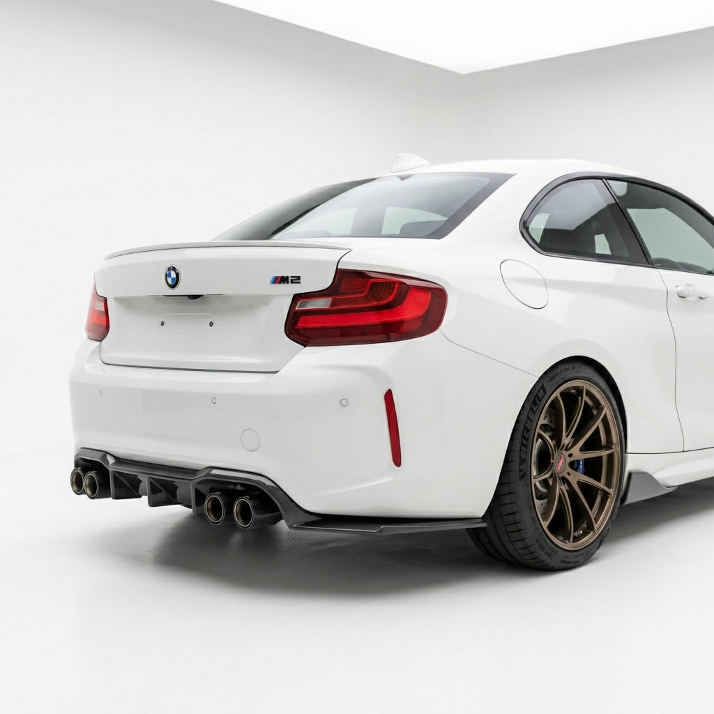 Carbon Corp. BMW M2 F87 rear diffuser and side extensions in gloss carbon fibre installed on a white sports car