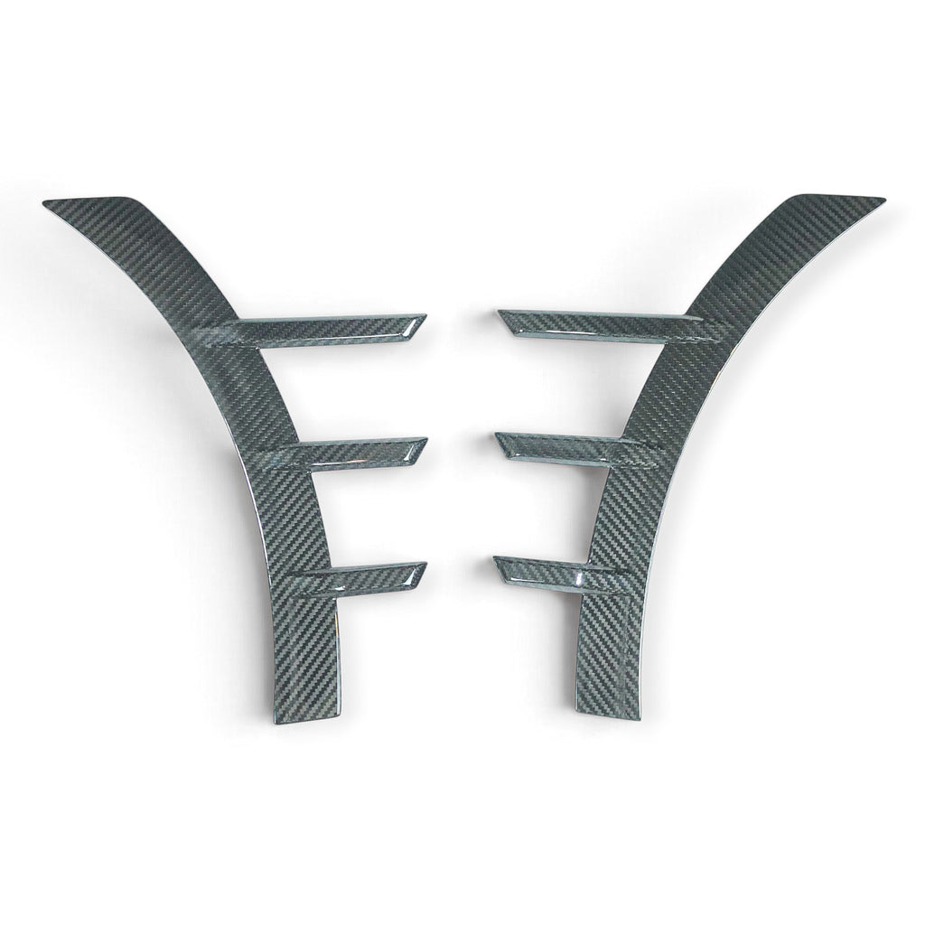 Carbon Corp. glossy carbon fibre front arch trim extensions for BMW M2 G87 with a motorsport-inspired design.