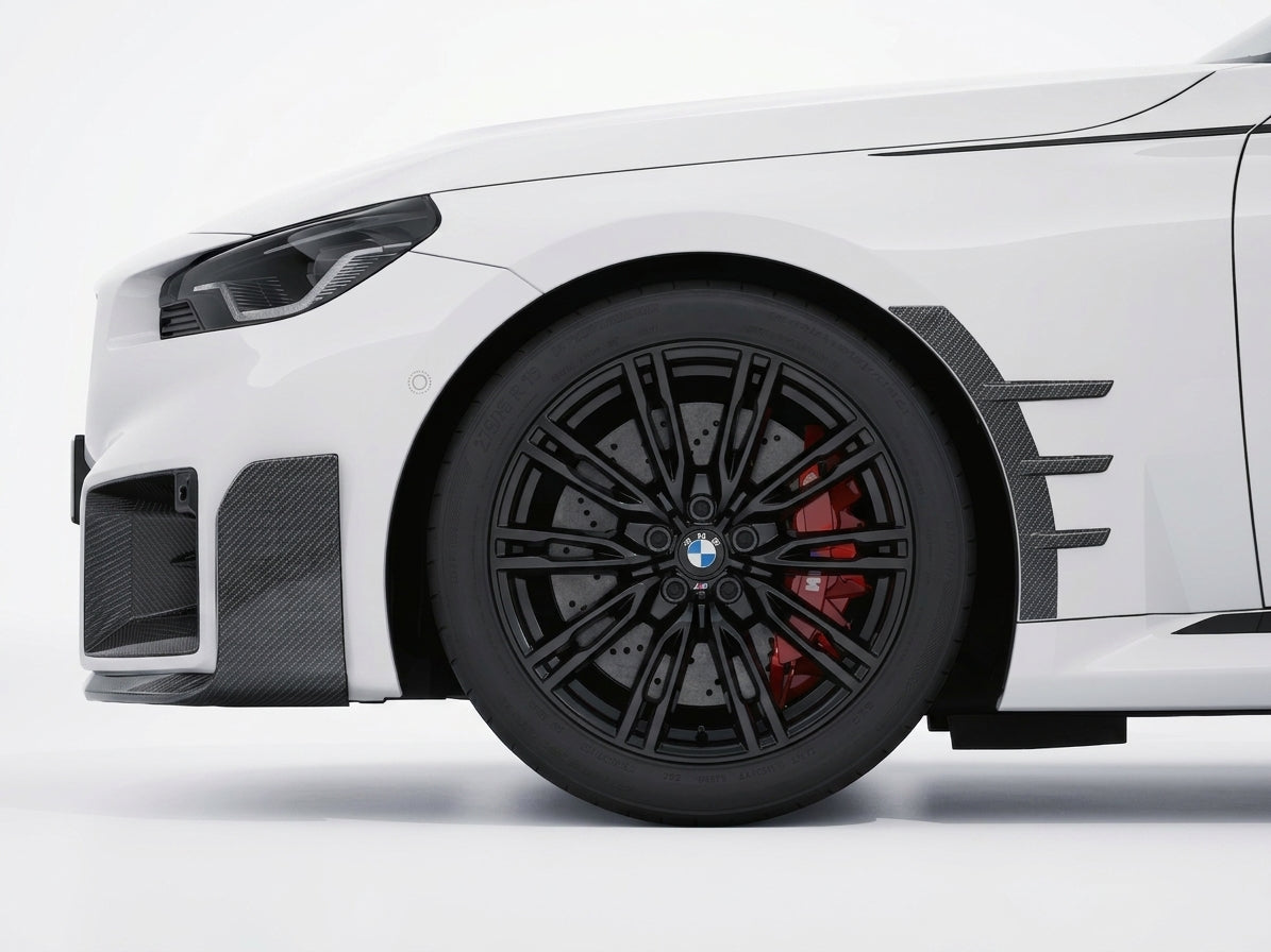 Carbon Corp. carbon fibre front arch trim on a white BMW M2 G87, featuring a high-gloss motorsport-inspired design.
