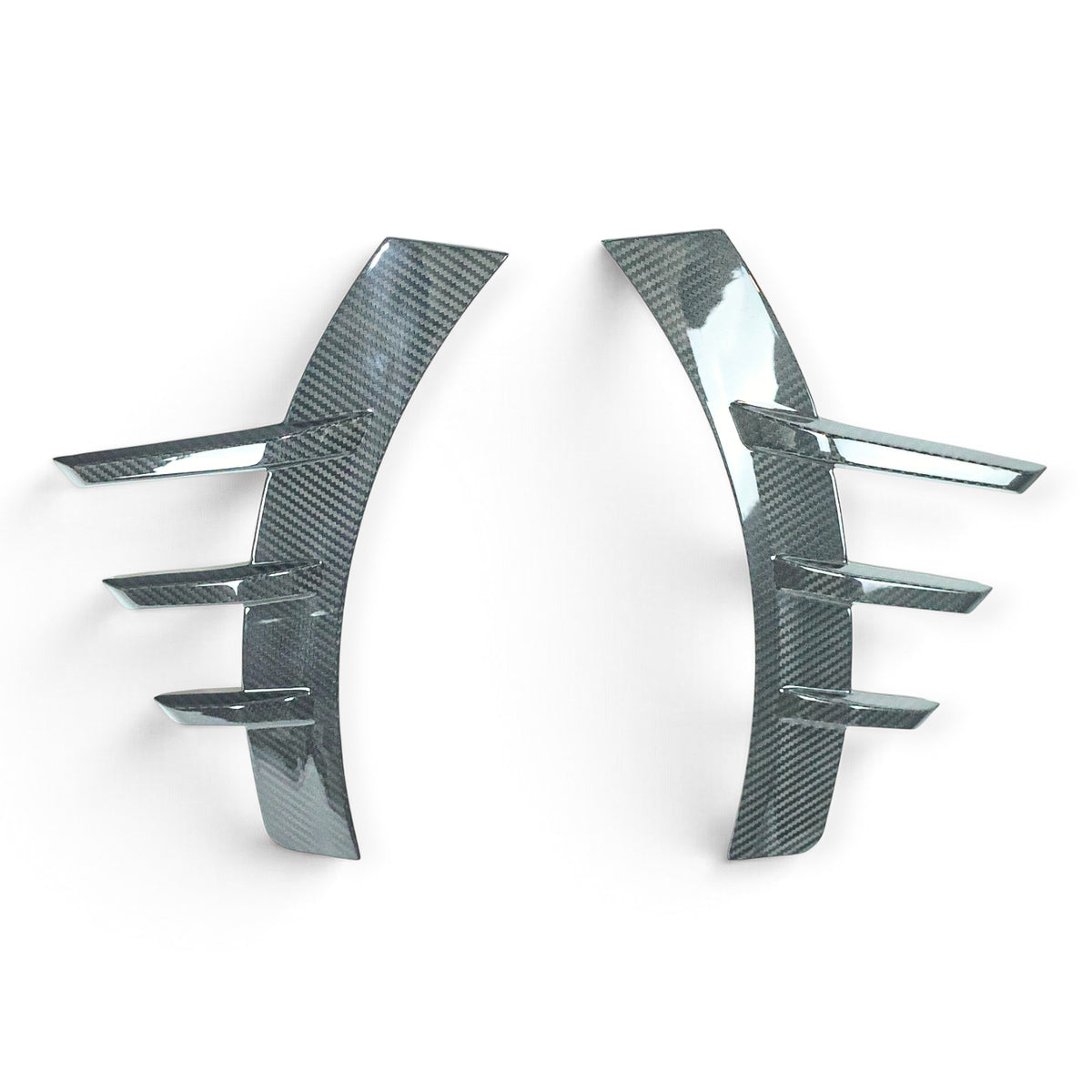 Carbon Corp. glossy carbon fibre rear wheel arch trim for BMW M2 G87 with aggressive MP style aerodynamic fins.