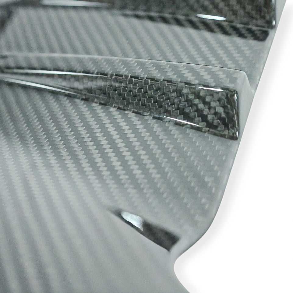 Carbon Corp. BMW M2 G87 carbon fibre rear bumper trim with a high-gloss finish and detailed weave pattern.