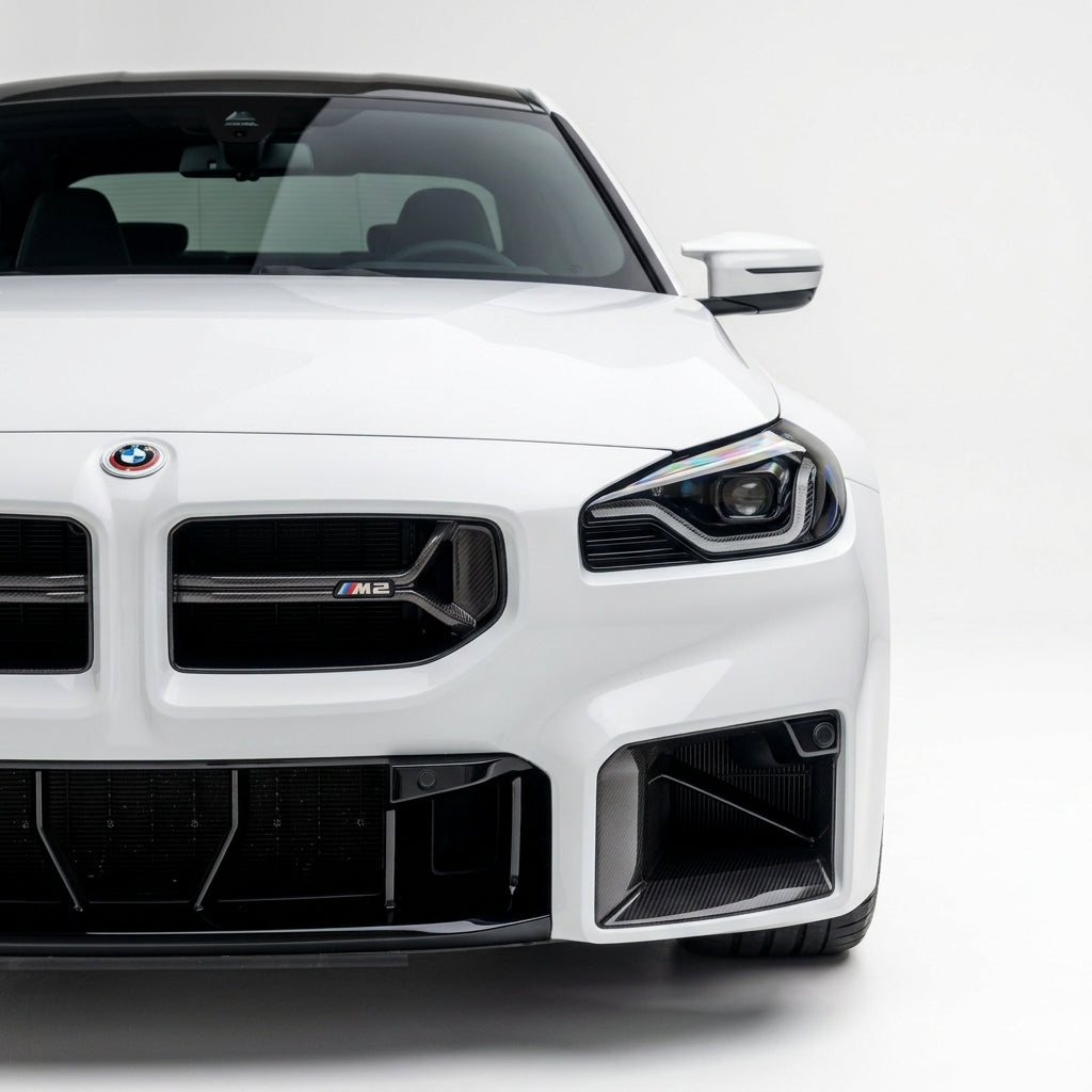 Carbon Corp. CSL style carbon fibre front grille on a white BMW M2 G87, featuring a minimalist open-bar design.