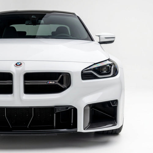 Carbon Corp. CSL style carbon fibre front grille on a white BMW M2 G87, featuring a minimalist open-bar design.