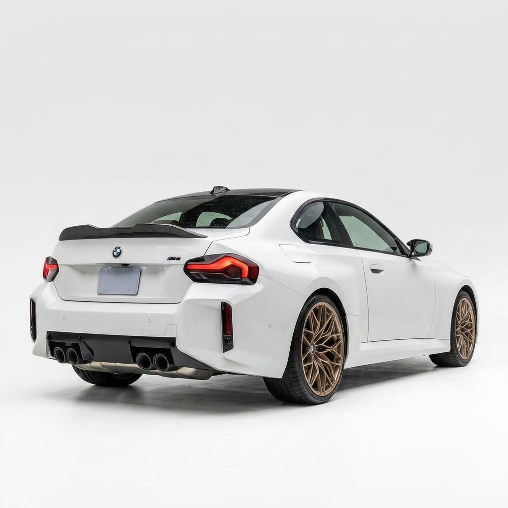 Carbon Corp. M Performance style carbon fibre lip spoiler installed on the rear trunk of a white BMW M2 G87