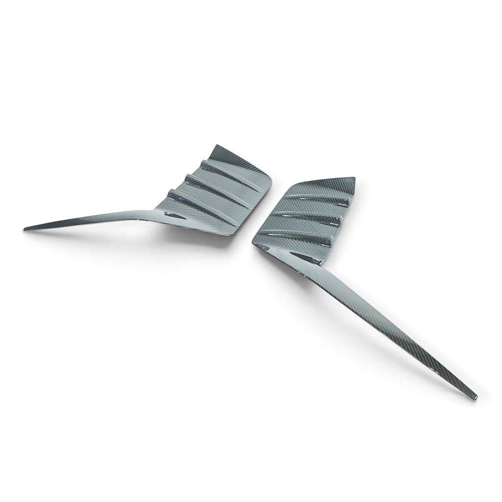 Carbon Corp. BMW M2 G87 carbon fibre rear bumper trim set with a glossy finish and race-inspired aerodynamic design.