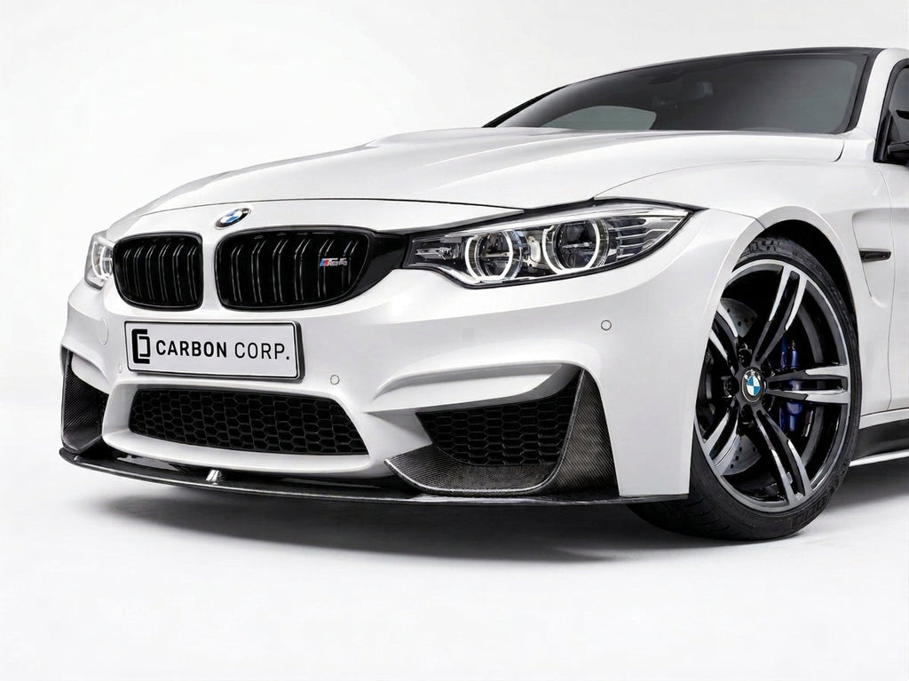 Carbon Corp. dry carbon fiber MP style front splitter installed on a white BMW M4 F82 front bumper