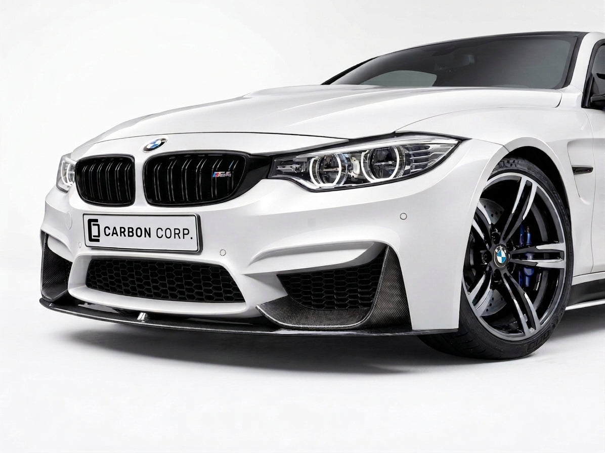 Carbon Corp. dry carbon fiber MP style front splitter installed on a white BMW M4 F82 front bumper