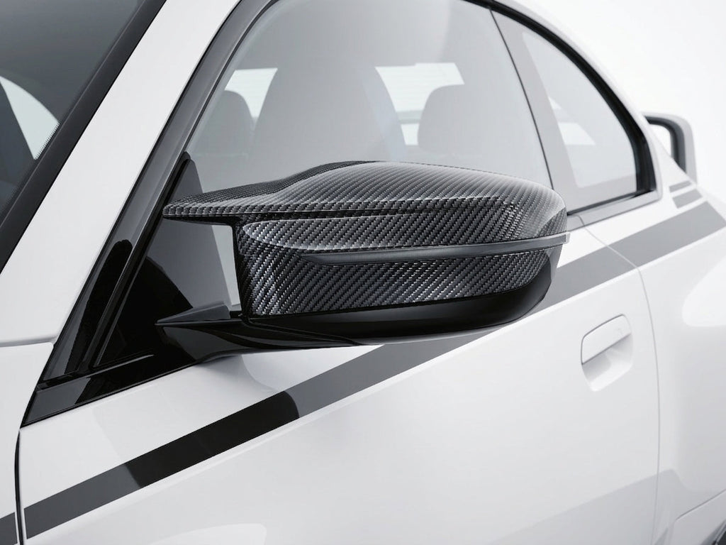 Carbon Corp. carbon fiber wing mirror cover installed on a white BMW G87 G80 G82 performance car