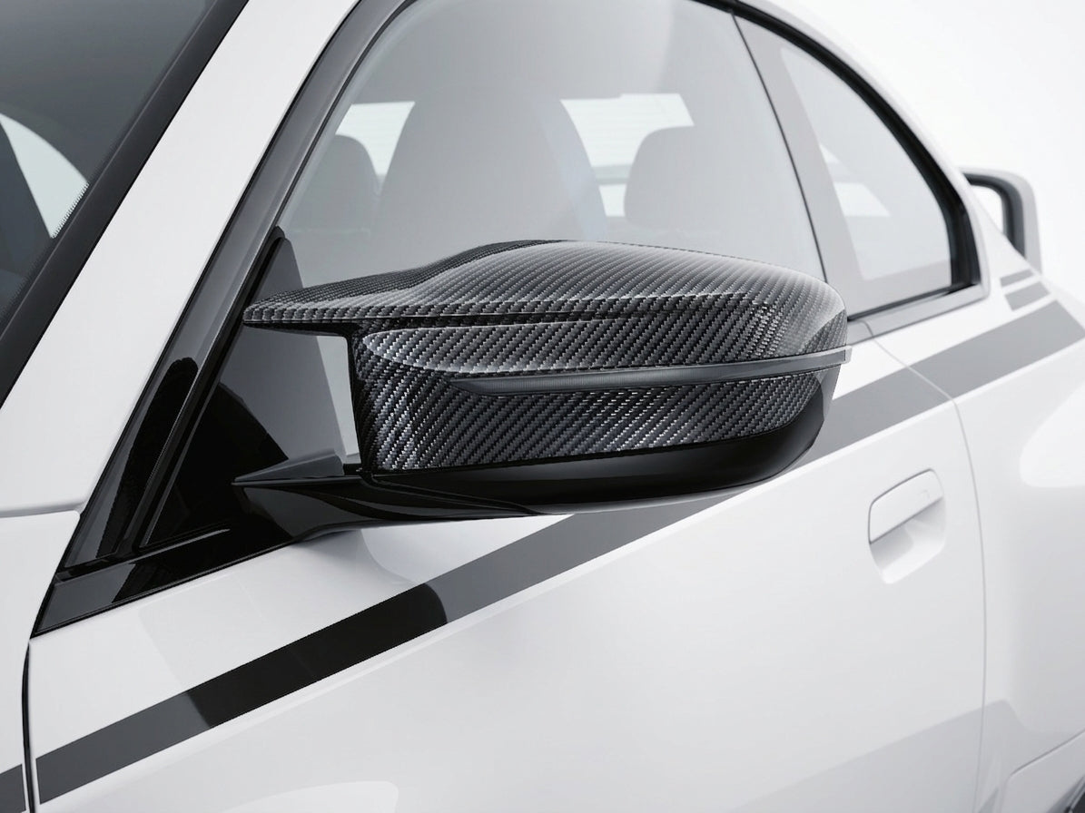 Carbon Corp. carbon fiber wing mirror cover installed on a white BMW G87 G80 G82 performance car