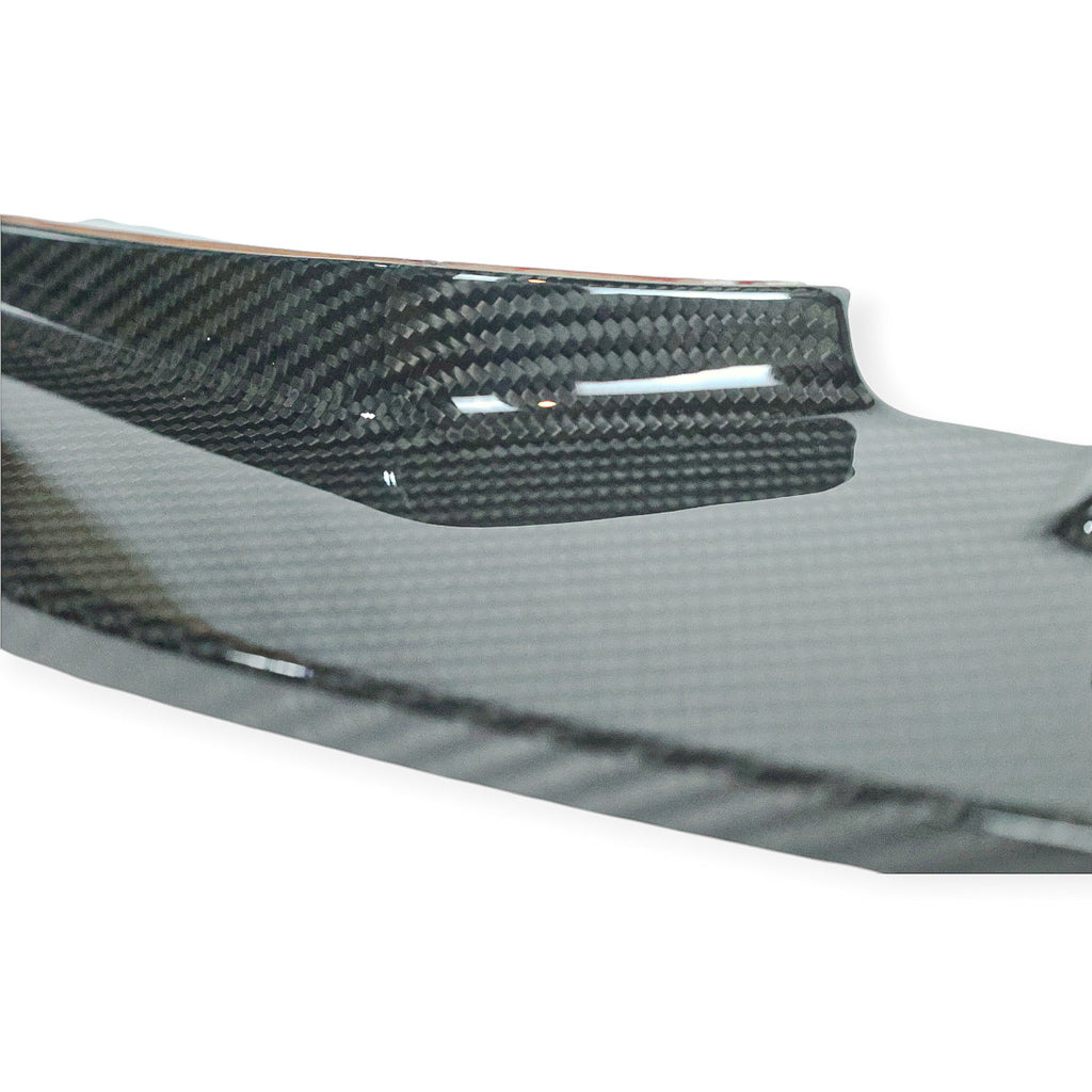 Carbon Corp. GT4 style dry carbon fiber front splitter for BMW M3 and M4 with a high-gloss weave finish.