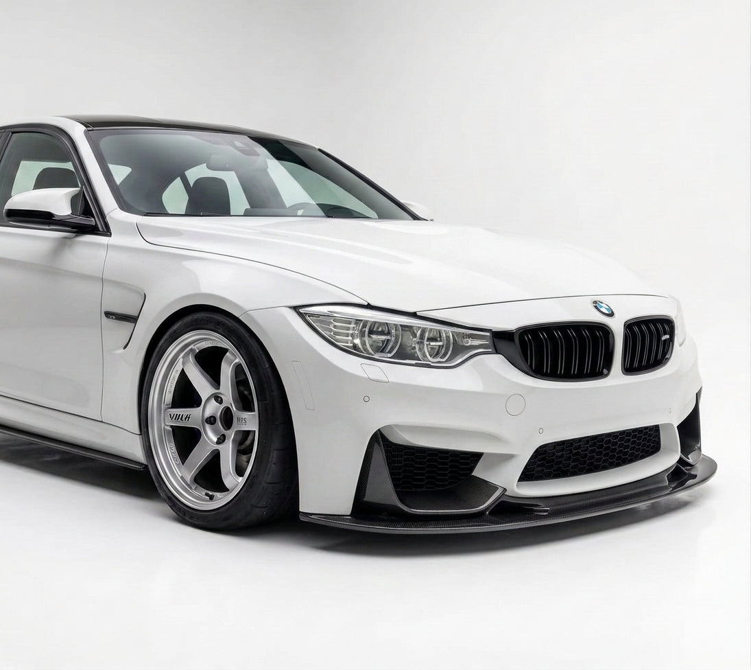 Carbon Corp. GT4 style dry carbon fiber front splitter installed on a white BMW M3 F80 with a high-gloss finish.