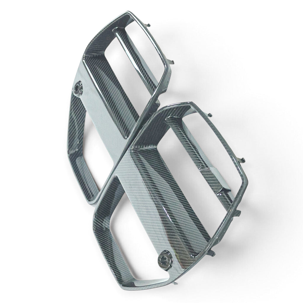 Carbon Corp. V-style carbon fibre front grille for BMW M3 G80 and M4 G82 with integrated ACC radar module cutouts.